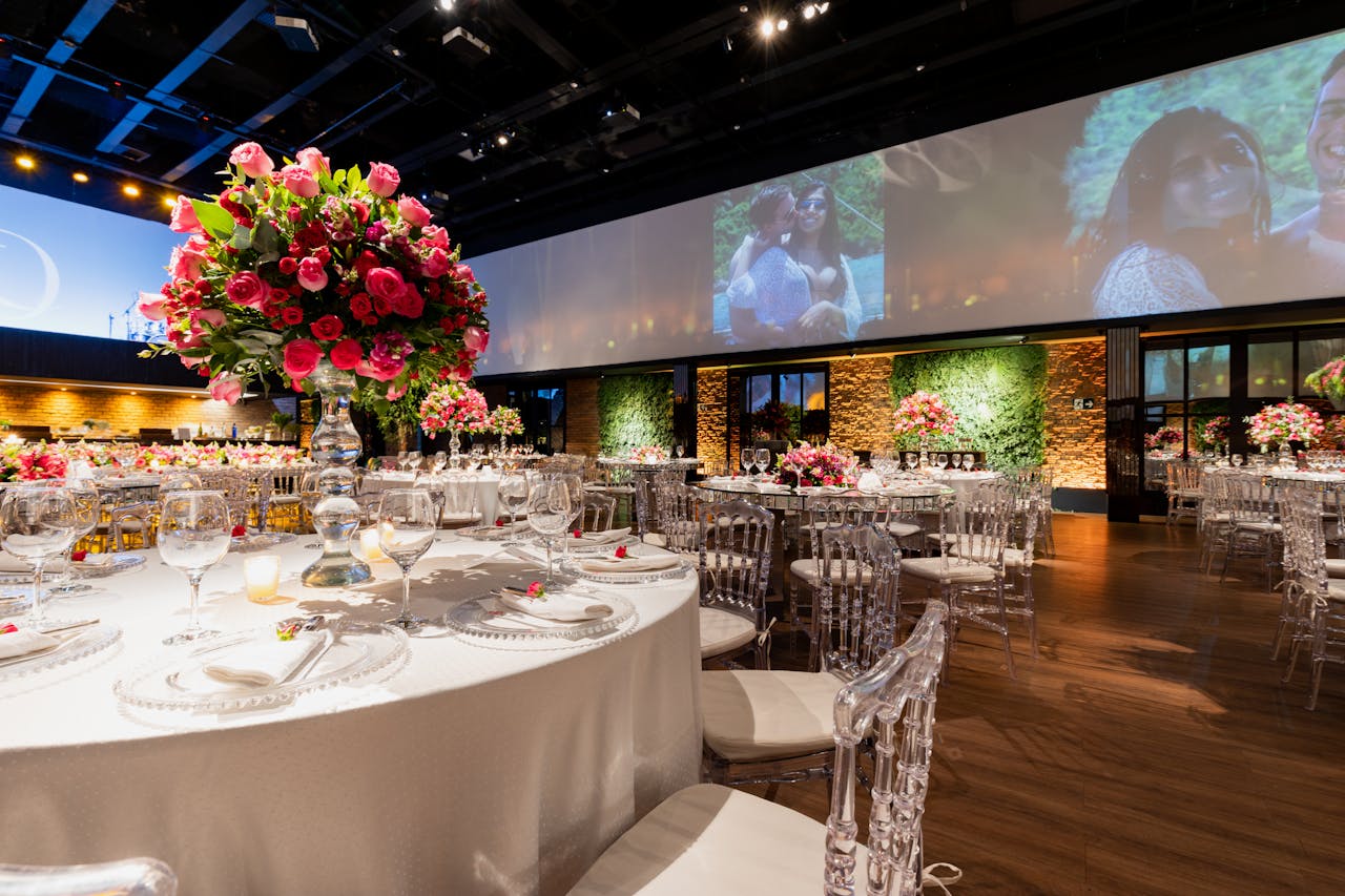 Services Stunning wedding reception setup with elegant floral centerpieces and ambient lighting.